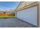 Exterior garage with white door and backyard view; good storage and parking space at 2080 S King St, Denver, CO 80219