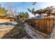 Landscaped backyard featuring a stone pathway and wooden fence offering privacy and charm at 1149 S Kittredge St, Aurora, CO 80017