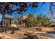 Charming backyard with a stone border surrounding the grass, trees, and a partial view of the deck at 1149 S Kittredge St, Aurora, CO 80017