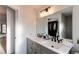 Bathroom includes double sink vanity and large mirror; walk-in closet is reflected in mirror at 1149 S Kittredge St, Aurora, CO 80017