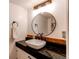 Updated bathroom featuring modern vanity with new fixtures, mirror, and lighting at 1149 S Kittredge St, Aurora, CO 80017