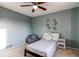 Bedroom with blue walls features a bed, a side table, a decorative flower and beanbag chair at 1149 S Kittredge St, Aurora, CO 80017