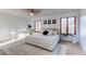 Bright bedroom with neutral tones, a decorative rug, and three windows with wood trim at 1149 S Kittredge St, Aurora, CO 80017