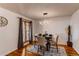 Cozy dining room featuring hardwood floors, a modern light fixture, large windows, and seating for four at 1149 S Kittredge St, Aurora, CO 80017