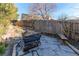 Backyard fire pit area with stone patio and wooden benches for seating at 1149 S Kittredge St, Aurora, CO 80017