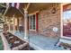 Inviting front porch with brick facade, decorative columns, and a cozy seating area at 1149 S Kittredge St, Aurora, CO 80017