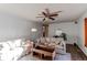 Bright living room with neutral furniture, hardwood floors, a ceiling fan, and a cozy atmosphere at 1149 S Kittredge St, Aurora, CO 80017