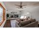 Comfortable living room featuring a brick fireplace, ceiling fan, neutral-toned furniture, and natural light at 1149 S Kittredge St, Aurora, CO 80017