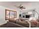 Comfortable living room featuring a fireplace, ceiling fan, neutral-toned furniture, and a large window at 1149 S Kittredge St, Aurora, CO 80017