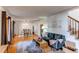 Bright living room with hardwood floors, a comfortable sofa, a dining area, and lots of natural light at 1149 S Kittredge St, Aurora, CO 80017