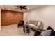 Finished basement living room features brick accent wall and cozy seating, blending character and comfort at 1149 S Kittredge St, Aurora, CO 80017