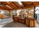 Covered outdoor kitchen featuring built-in stainless steel grill and wood cabinets at 1149 S Kittredge St, Aurora, CO 80017