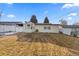 Spacious backyard featuring a well-maintained lawn, mature trees, and a white fence at 3460 S Eudora St, Denver, CO 80222