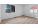 Bright bedroom with wood-look floors and ample natural light from two large windows at 3460 S Eudora St, Denver, CO 80222