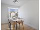 Bright dining room features a bay window and modern light fixture at 3460 S Eudora St, Denver, CO 80222