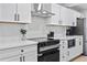 Modern kitchen with stainless steel appliances, white cabinets, and stylish lighting at 3460 S Eudora St, Denver, CO 80222