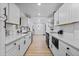 Bright, modern kitchen with white cabinetry, stainless steel appliances, and wood-look flooring at 3460 S Eudora St, Denver, CO 80222