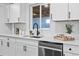 Modern kitchen with white cabinets, quartz countertops, and stainless steel dishwasher at 3460 S Eudora St, Denver, CO 80222