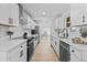 Modern kitchen with sleek white cabinets, stainless steel appliances, and stylish fixtures at 3460 S Eudora St, Denver, CO 80222