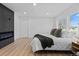 Bright main bedroom features a modern fireplace, and wood floors at 3460 S Eudora St, Denver, CO 80222