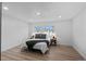 Bright main bedroom features a modern lamps and wood floors at 3460 S Eudora St, Denver, CO 80222