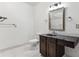 Bathroom with dark vanity, tiled floor, and mirrored medicine cabinet at 309 E Highline Cir # 103, Centennial, CO 80122