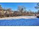 Building exterior view with snow-covered ground and trees at 309 E Highline Cir # 103, Centennial, CO 80122