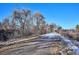 Pathway alongside trees and snow-covered ground at 309 E Highline Cir # 103, Centennial, CO 80122