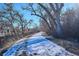 Pathway with trees, snow, and views of nearby buildings at 309 E Highline Cir # 103, Centennial, CO 80122