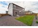 Backyard with gravel, grass, and a two-story house at 1123 Sunrise Dr, Brighton, CO 80603