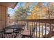 Private balcony with table and chairs, overlooking trees at 10273 E Peakview Ave # D202, Englewood, CO 80111