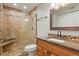 Updated bathroom with walk-in shower and granite vanity at 10273 E Peakview Ave # D202, Englewood, CO 80111