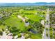 Stunning aerial view overlooking lush green spaces, winding trails, and serene ponds, a perfect residential area at 9765 W 77Th Dr, Arvada, CO 80005