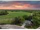 Stunning aerial view of home, landscape and open land with captivating sunset in background at 9765 W 77Th Dr, Arvada, CO 80005
