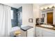 Bathroom featuring tiled shower and tub, white vanity, and dark blue tile at 9765 W 77Th Dr, Arvada, CO 80005
