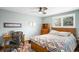 Comfortable bedroom with ceiling fan, a window with shutters, and wooden desk at 9765 W 77Th Dr, Arvada, CO 80005