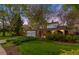 Charming home exterior with well-maintained lawn and mature trees creating a park-like setting at 9765 W 77Th Dr, Arvada, CO 80005