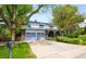 Charming two-story home featuring a wide driveway, well-maintained lawn, and inviting curb appeal at 9765 W 77Th Dr, Arvada, CO 80005