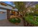 Charming home featuring a welcoming porch with classic archways and a beautifully landscaped front yard at 9765 W 77Th Dr, Arvada, CO 80005