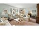 Bright living room filled with natural light, with plush seating and elegant furnishings at 9765 W 77Th Dr, Arvada, CO 80005