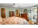 Spacious main bedroom with hardwood floors, ceiling fan, and ensuite bathroom access at 9765 W 77Th Dr, Arvada, CO 80005