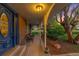 Inviting front porch with seating area, brick accents, and charming curb appeal at 9765 W 77Th Dr, Arvada, CO 80005