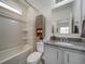 Well-lit bathroom with granite countertops, a vanity, and a shower-tub combo at 10379 Vaughn Way, Commerce City, CO 80022