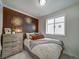 Stylish bedroom with a decorative headboard and rustic nightstand at 10379 Vaughn Way, Commerce City, CO 80022