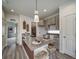 Kitchen island with granite countertop, bar stools, and stylish pendant lighting at 10379 Vaughn Way, Commerce City, CO 80022