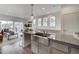 Bright kitchen features stainless steel sink, granite countertops and island that opens up to the living area at 10379 Vaughn Way, Commerce City, CO 80022