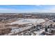 Expansive aerial view captures a neighborhood with a frozen lake in the distance at 10092 Lee St, Broomfield, CO 80021