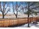 Fenced backyard view showcases the natural landscape in a suburban setting at 10092 Lee St, Broomfield, CO 80021