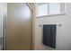 Bathroom featuring frosted glass shower door, towel bar, and a window for natural light at 10092 Lee St, Broomfield, CO 80021