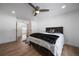 Well-lit bedroom with hardwood floors, ceiling fan, and a view through the doorway at 10092 Lee St, Broomfield, CO 80021